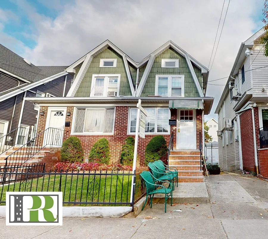 midwood - exterior of a semi-detached Dutch Colonial style house