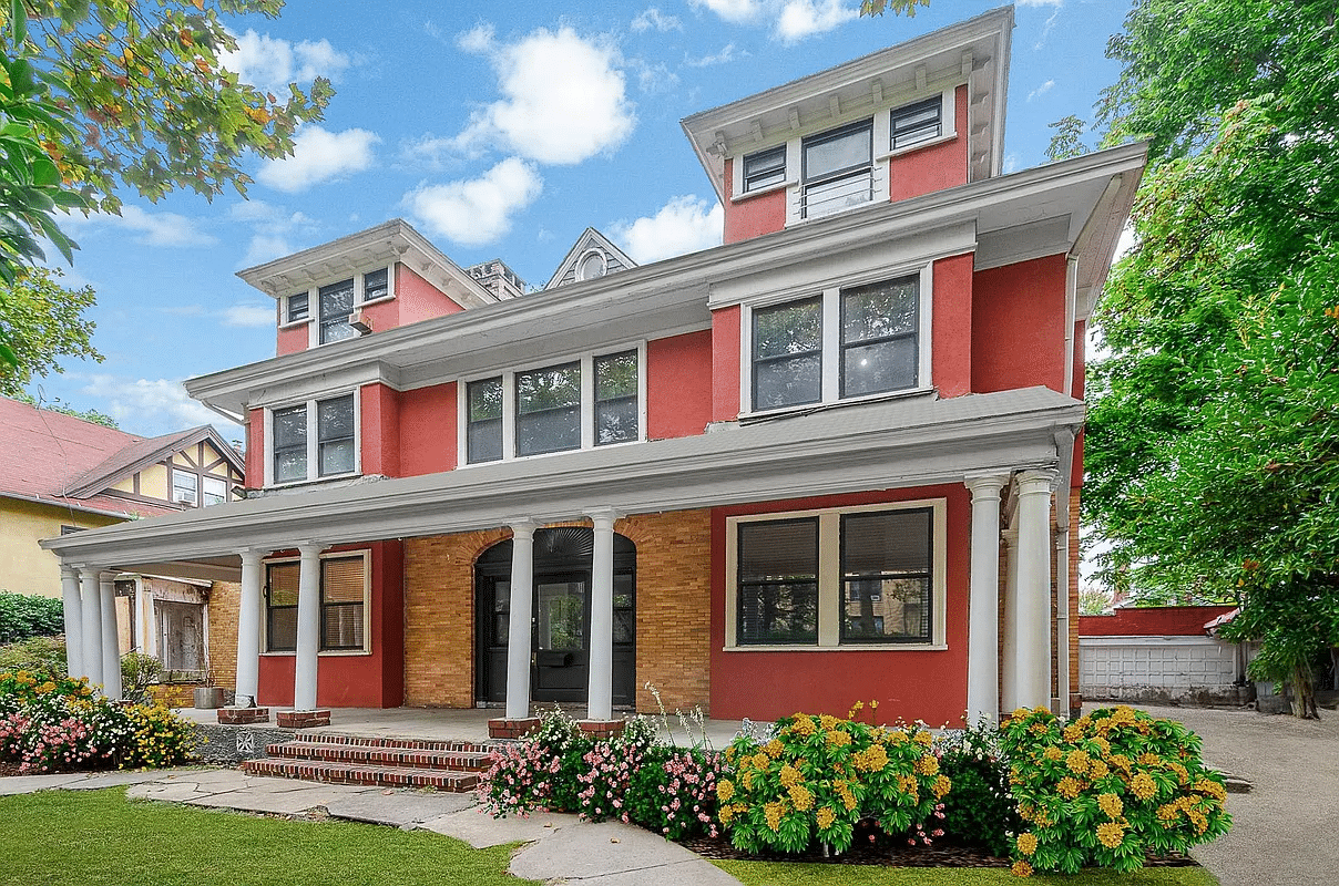 exterior of red house with porch